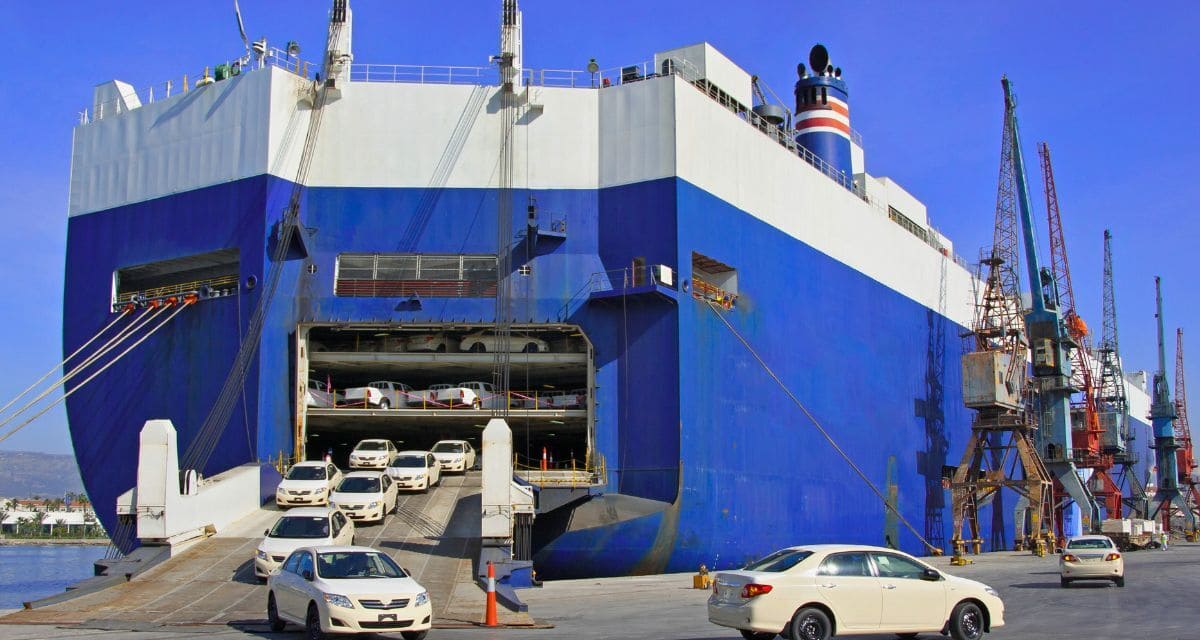 Roll-on roll-off ship unloading cars at port